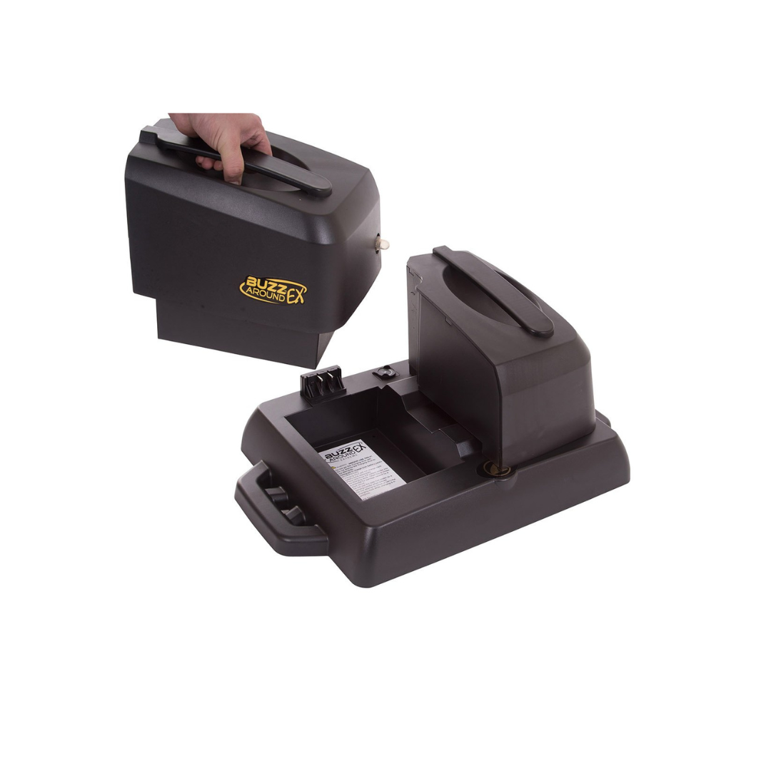 A person removes a black component labeled Blizzard Adapter from a base resembling the Battery Docking Station for Golden Tech Buzzaround EX & LX Scooters, featuring handles and compartments. The plain white background suggests an indoor charging setting.